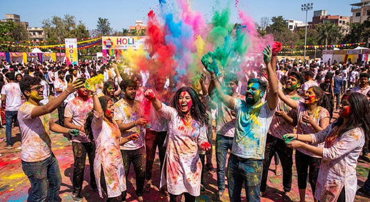 Group of people celebrating Holi festival throwing colorful powder in red yellow blue and green outdoors