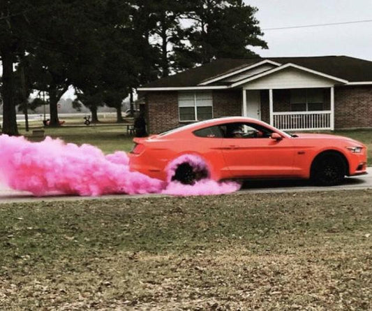 Red Mustang performing a burnout releasing a cloud of pink gender reveal powder
